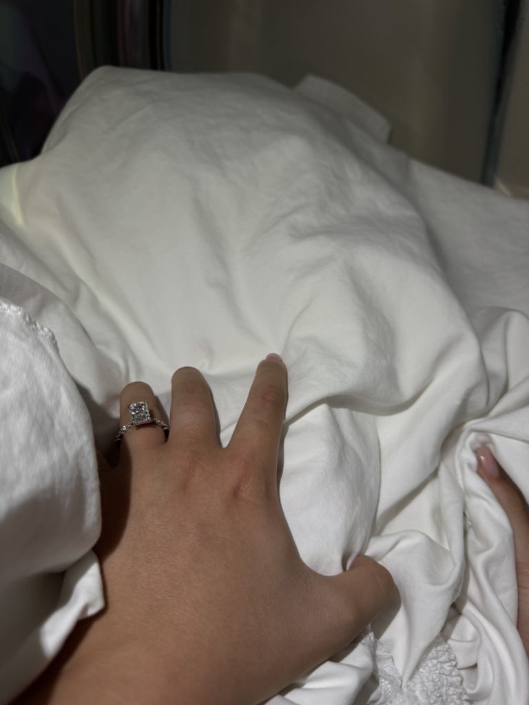 Engagement_ring_doing_laundry Grabbing sheets out of the drying while wearing engagement ring