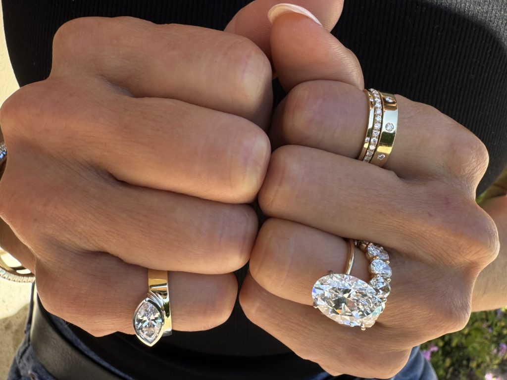 Diamond rings stacked together on the hands as accessories  