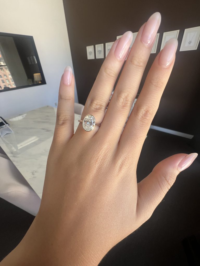 Thin bezel setting featured on the ring finder with an oval cut diamond 