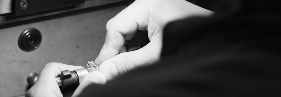 A jeweler's hands crafting an engagement ring